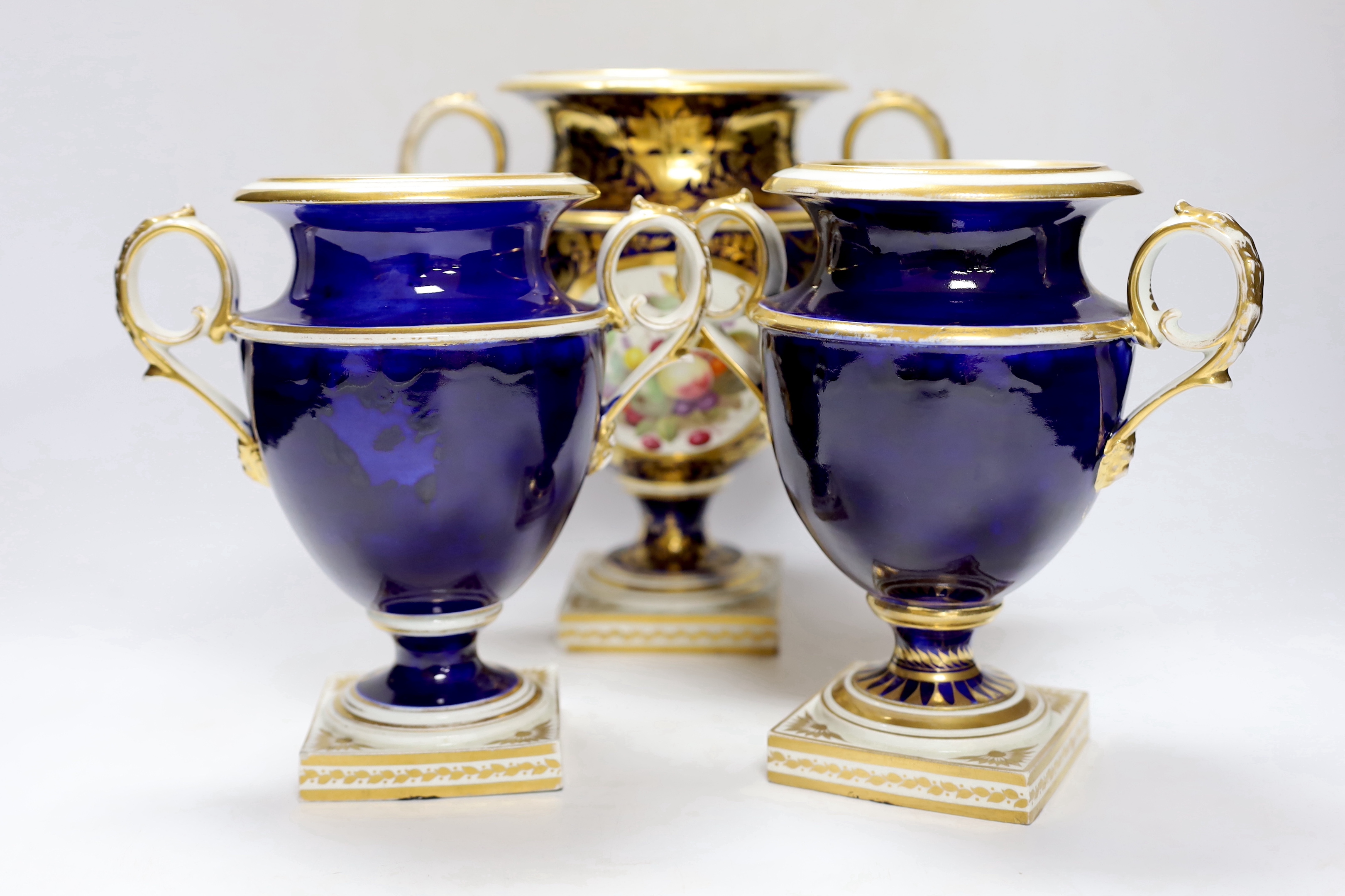 A garniture of three early 19th century Derby vases painted with fruit, tallest 23cm